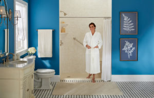 A homeowner standing in her walk-in shower